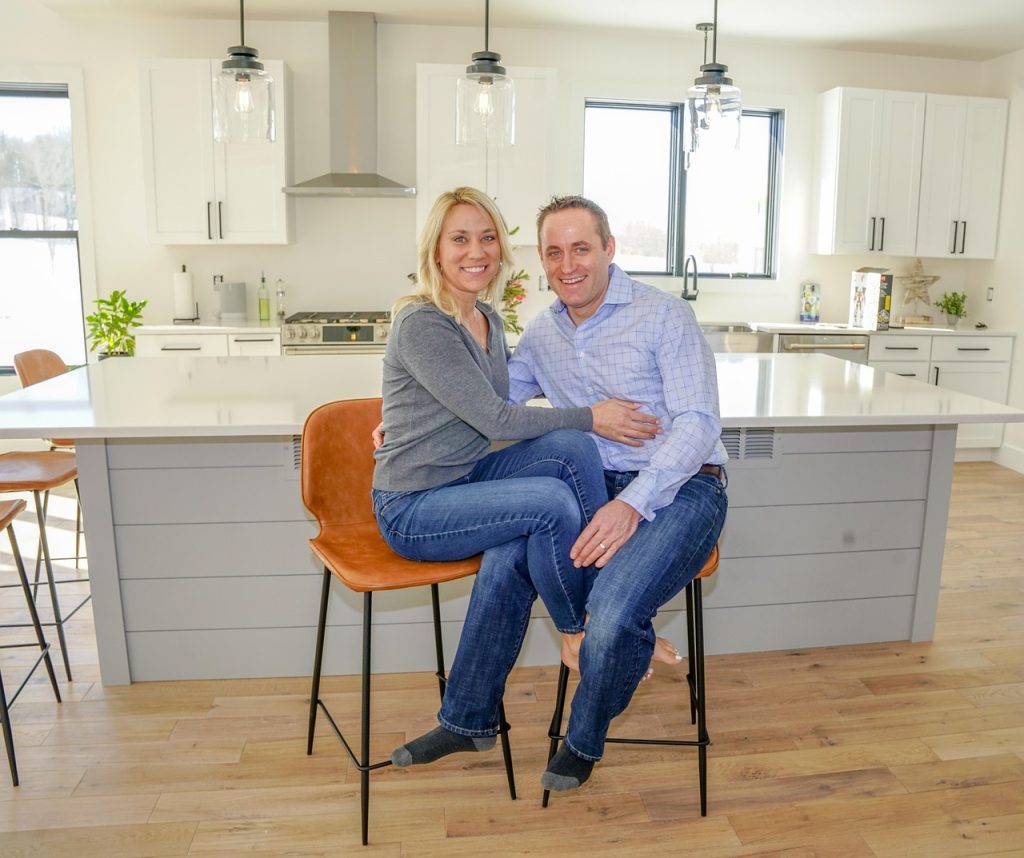 A happy couple in their kitchen with Corian countertops Toronto
